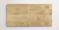 Nasco Stone + Tile Flatiron Beige decorative wall tiles stacked together to show the subtle variations in texture and hue.