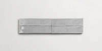 Four stacked 2" x 10" light grey ceramic tiles in a glossy finish