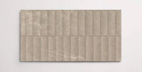 A single brown 10" x 30" porcelain tile resembling stone with a textured blind pattern and subtle veining