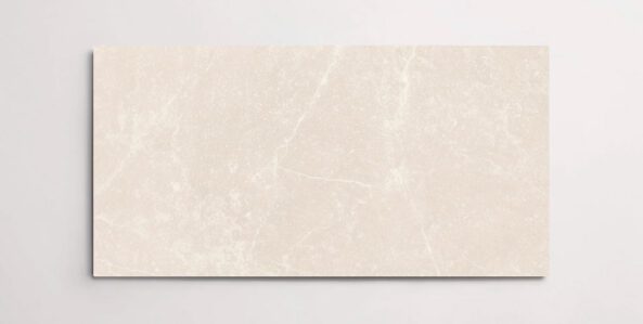 A single cream colored 10" x 30" stone-like porcelain tile with subtle veining