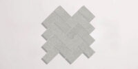 Nasco Stone + Tile Newen Grey Herringbone Mosaic porcelain tile.
